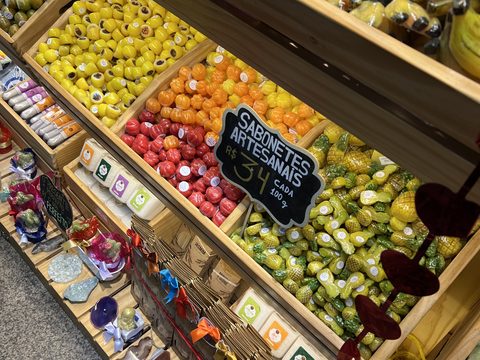 Market shelves of colourful sweets and fruit-shaped soaps