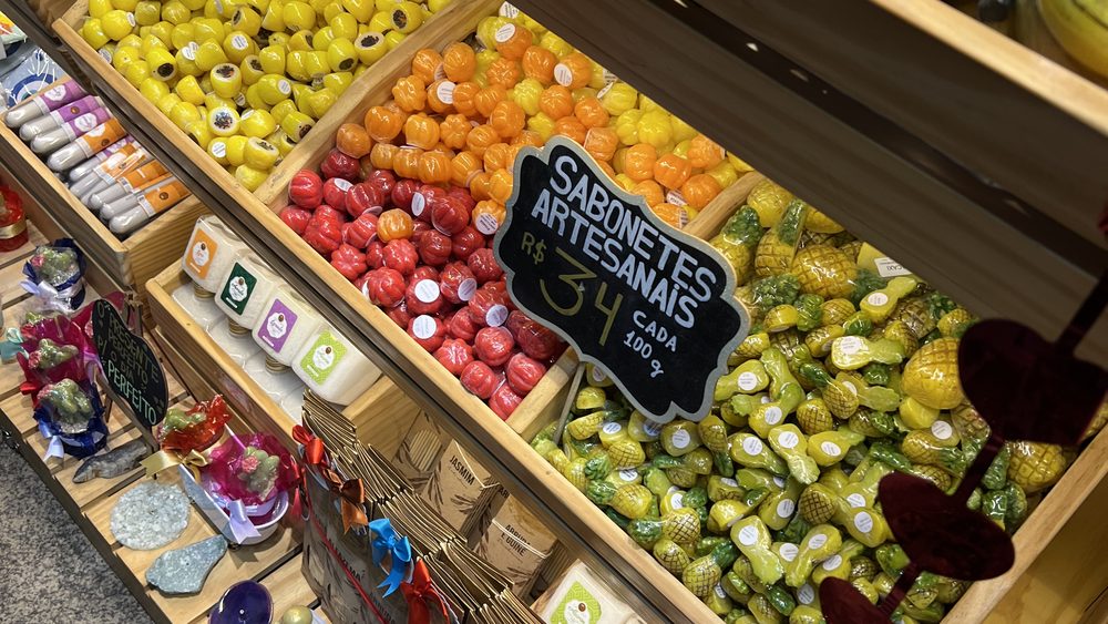 Market shelves of colourful sweets and fruit-shaped soaps