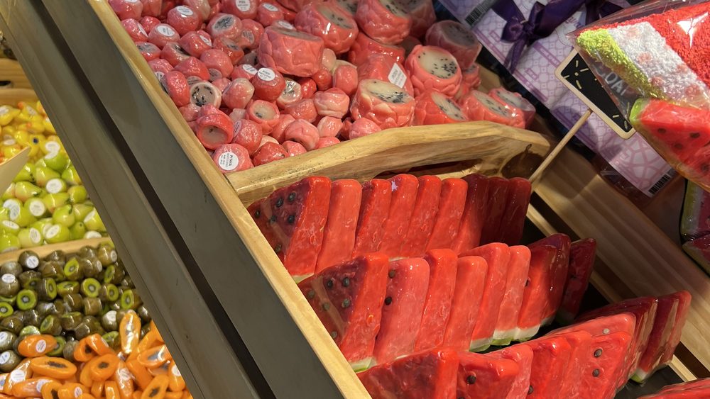 A display of sweets and fruit-shaped soaps in a market