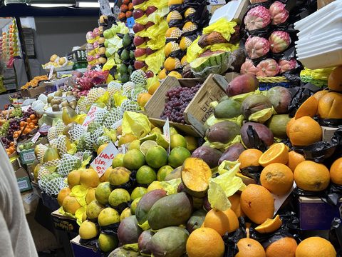 A market fruit stall piled high with fruit