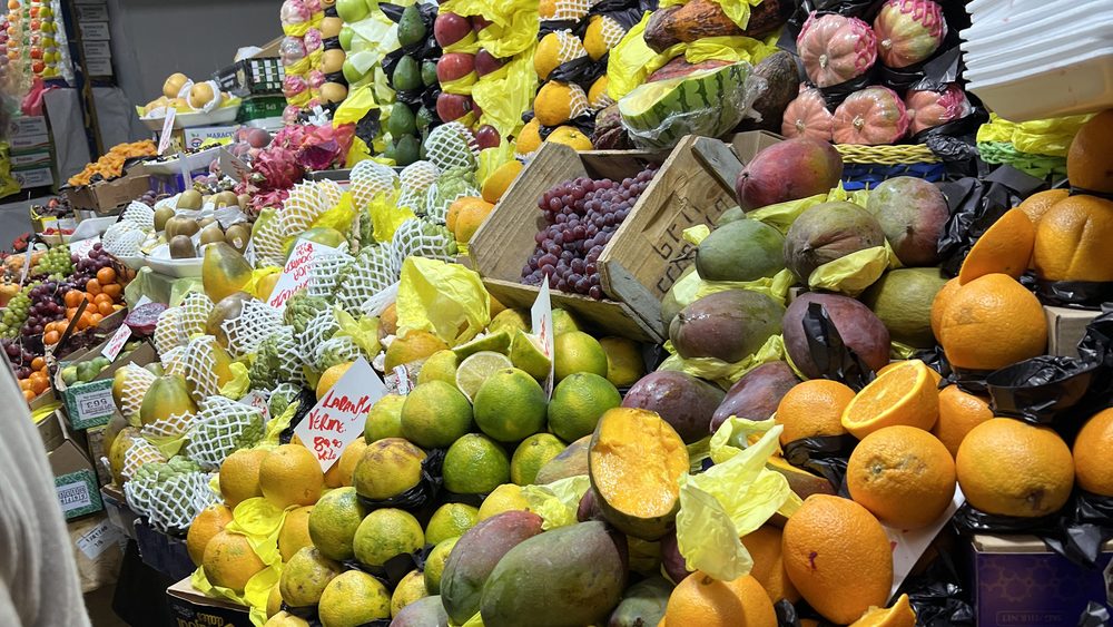 A market fruit stall piled high with fruit