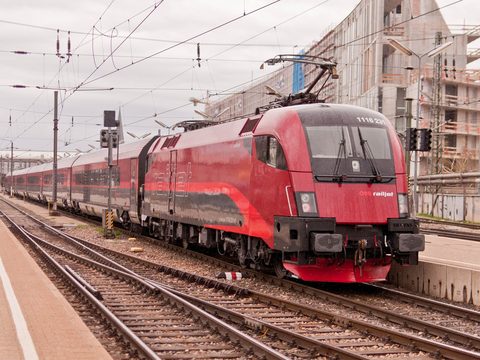 Red OBB Railjet locomotive at a station platform