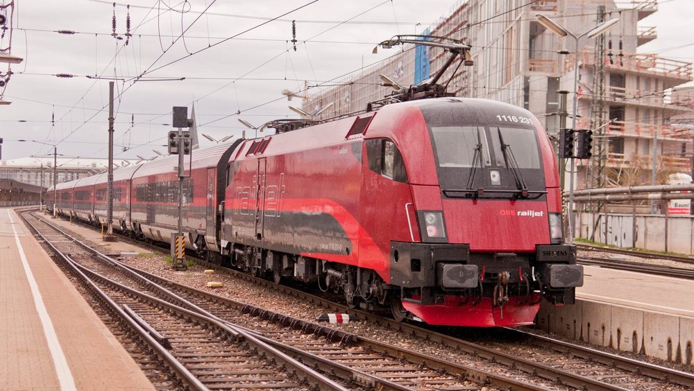 Red OBB Railjet locomotive at a station platform