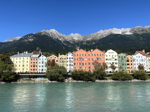 Colorful riverside apartment houses in Innsbruck below the Alps