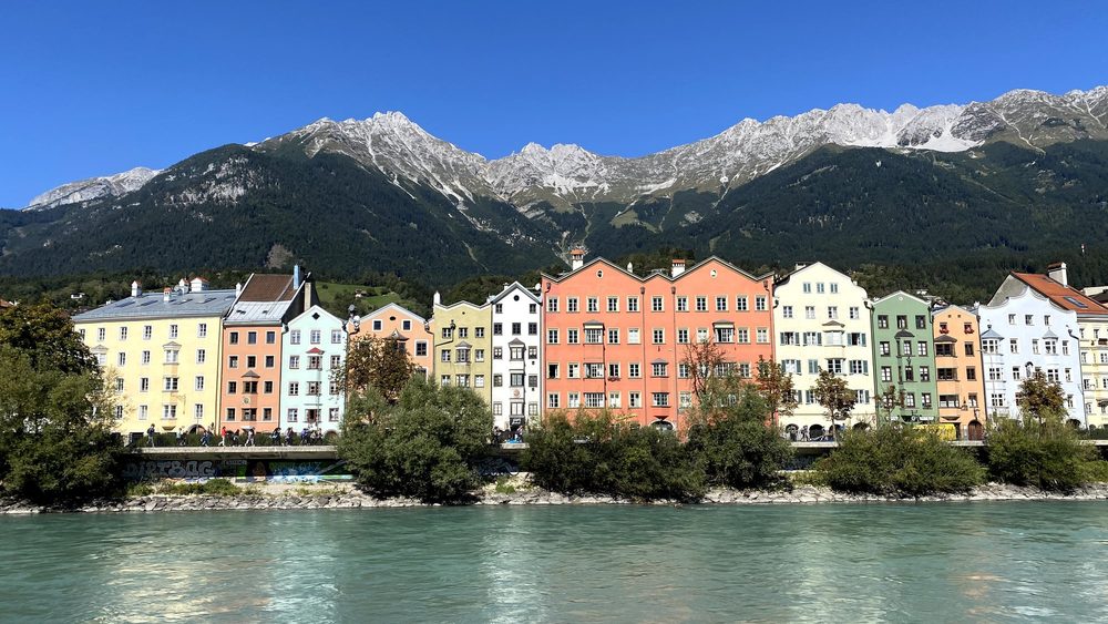 Colorful riverside apartment houses in Innsbruck below the Alps
