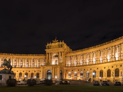 The Neue Burg wing of the Hofburg in Vienna, lit up at night on Heldenplatz