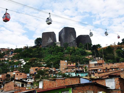 Biblioteca Espana and Metrocable cabins above Medellin hills