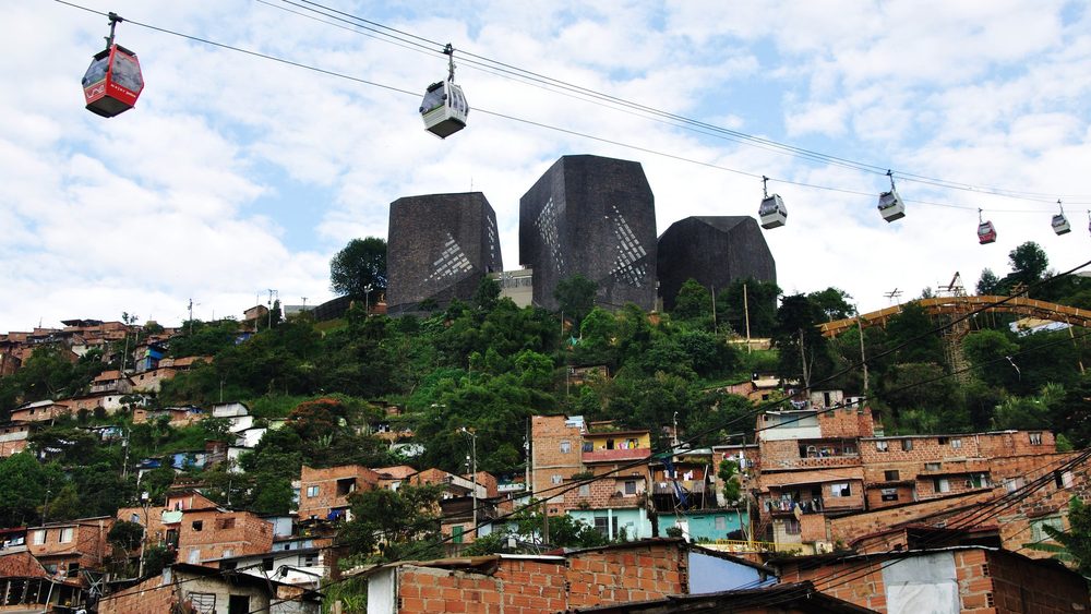 Biblioteca Espana and Metrocable cabins above Medellin hills
