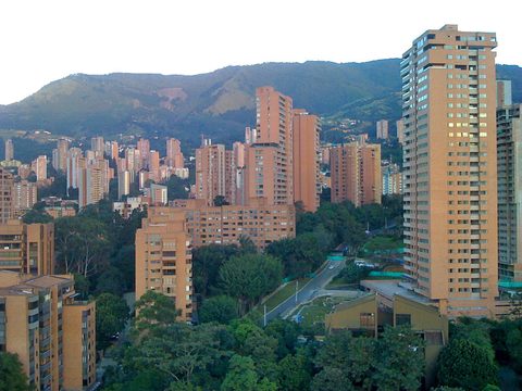 High-rise apartments of El Poblado in Medellin against green hills