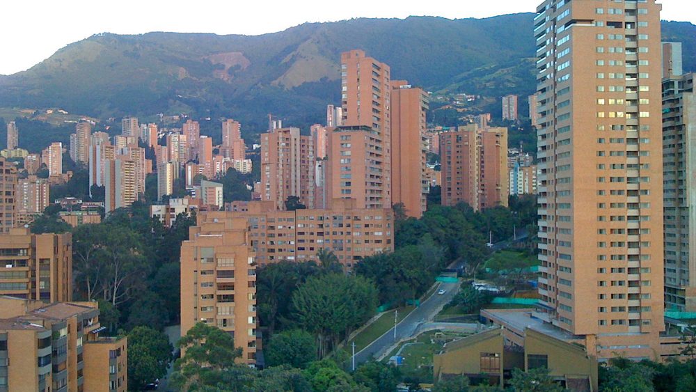 High-rise apartments of El Poblado in Medellin against green hills