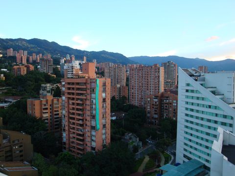 High-rise apartment towers in El Poblado, Medellin, with green hills behind