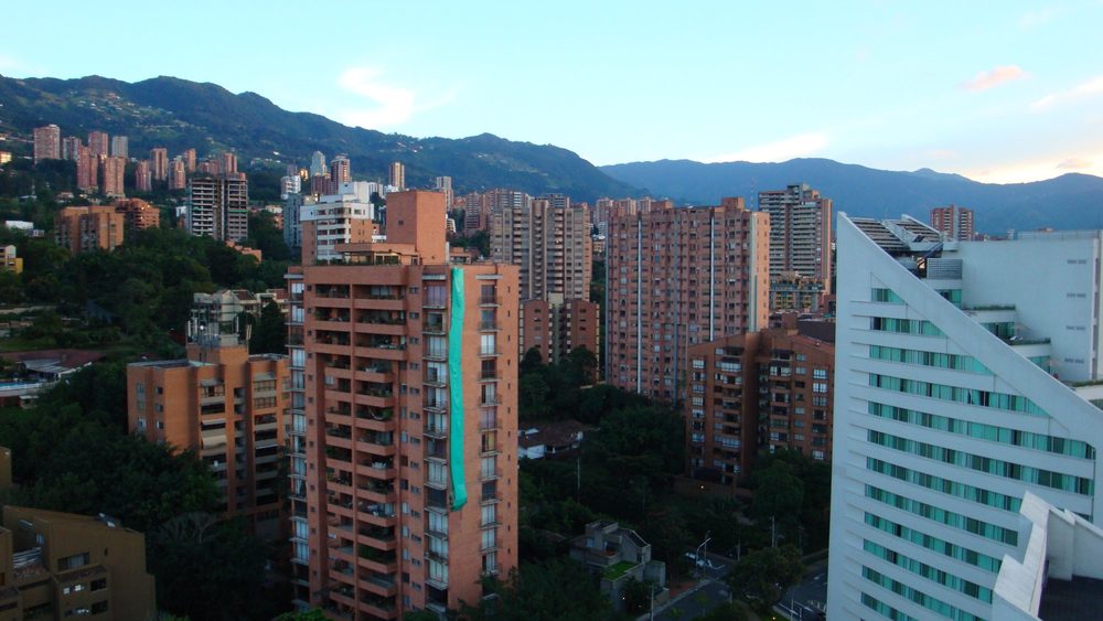 High-rise apartment towers in El Poblado, Medellin, with green hills behind