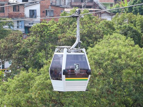 Metrocable gondola cabin over trees on Line K in Medellin