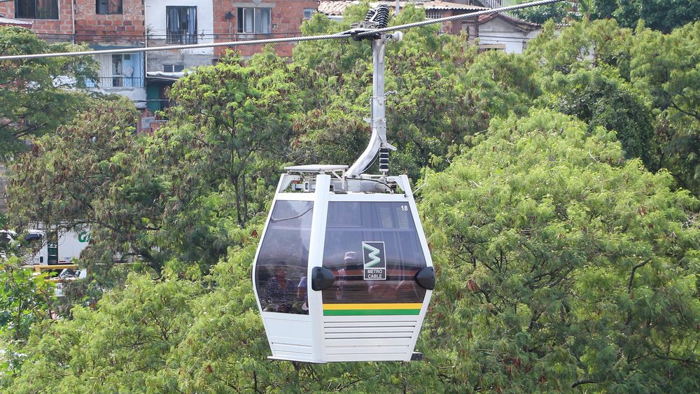 Metrocable gondola cabin over trees on Line K in Medellin