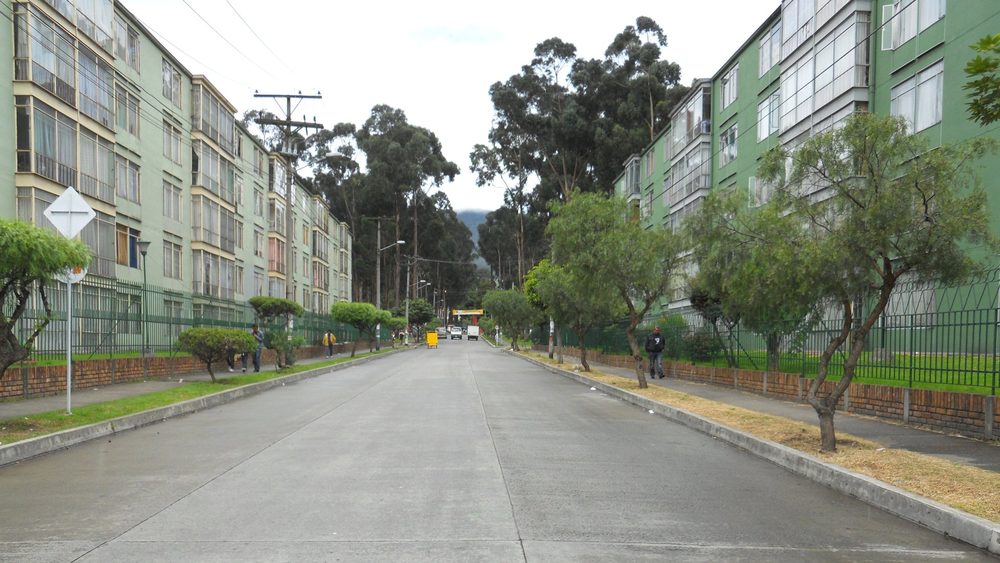 Tree-lined residential street with apartment blocks on Carrera 13 in Bogota