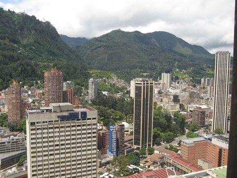 Bogota business district towers below the green Andes hills