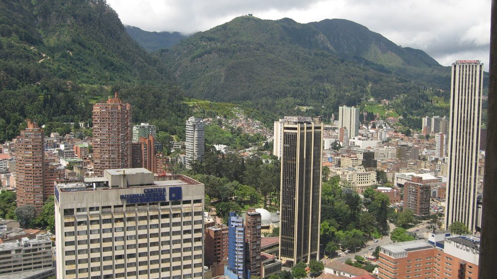 Bogota business district towers below the green Andes hills