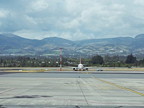 Aircraft on the runway at Mariscal Sucre International Airport with the Andes behind, Quito, Ecuador