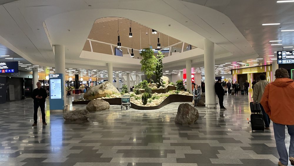 Arrivals hall at Helsinki Airport with a planted indoor garden