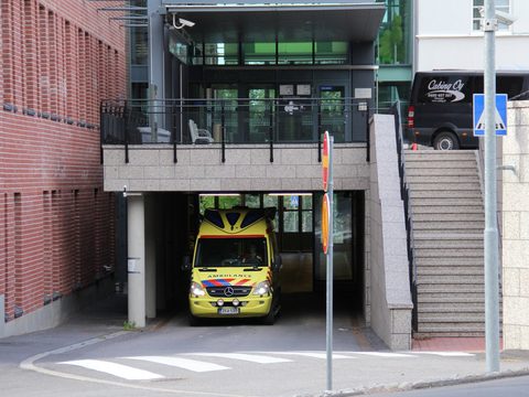 Yellow ambulance parked at the entrance of Malmi hospital in Helsinki