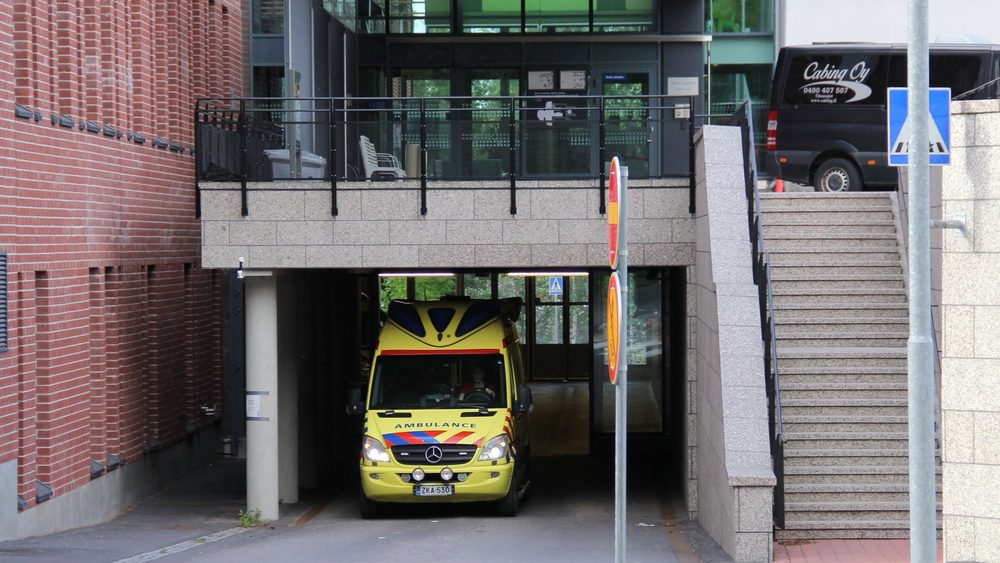 Yellow ambulance parked at the entrance of Malmi hospital in Helsinki