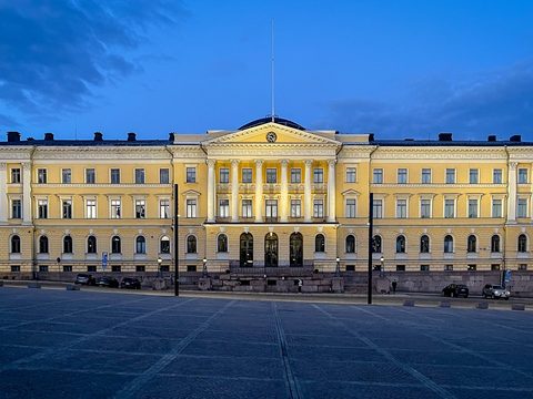 Yellow neoclassical state government office building in Helsinki at dusk