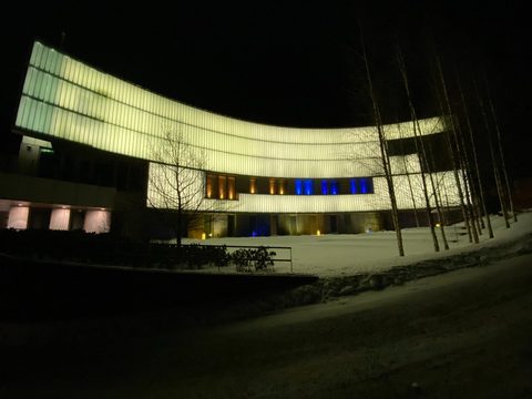 The US Embassy building in Helsinki lit up at night