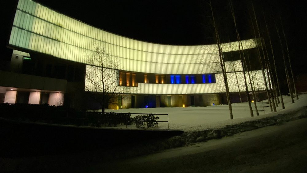 The US Embassy building in Helsinki lit up at night