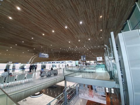 Departure hall of Terminal 2E at Paris Charles de Gaulle Airport with its curved wooden ceiling