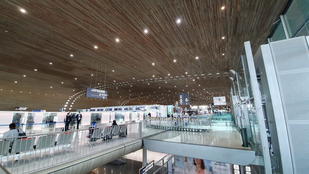 Departure hall of Terminal 2E at Paris Charles de Gaulle Airport with its curved wooden ceiling