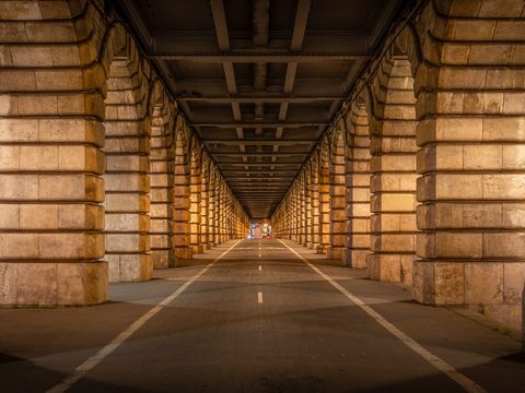 Long arched walkway beneath the Pont de Bercy in Paris