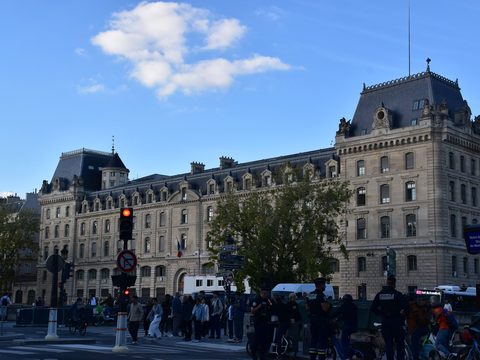 The Prefecture de Police building on the Ile de la Cite in Paris, with traffic and pedestrians on the street in front