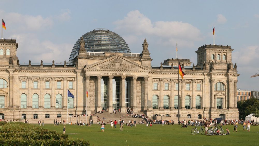 The Reichstag building in Berlin with its glass dome and lawn