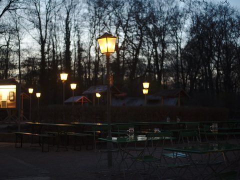Beer garden lanterns at dusk in Munich's Englischer Garten