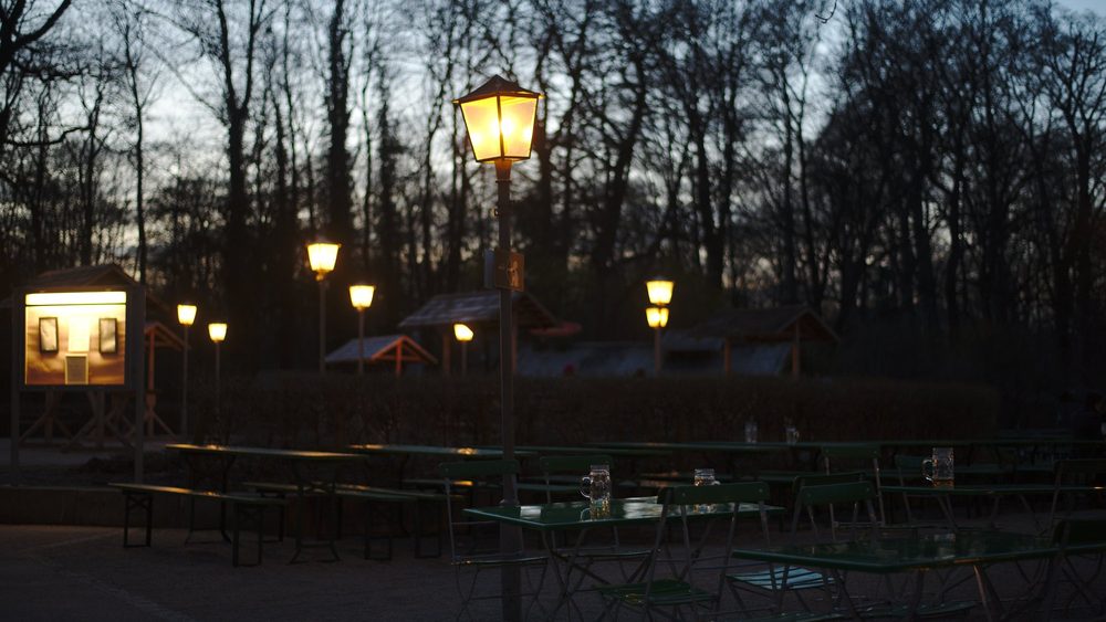 Beer garden lanterns at dusk in Munich's Englischer Garten