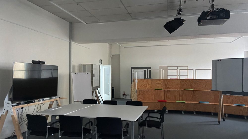 Empty meeting room in a German office with tables and screens