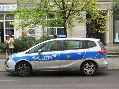 Blue and silver Berlin Polizei patrol car parked on a street