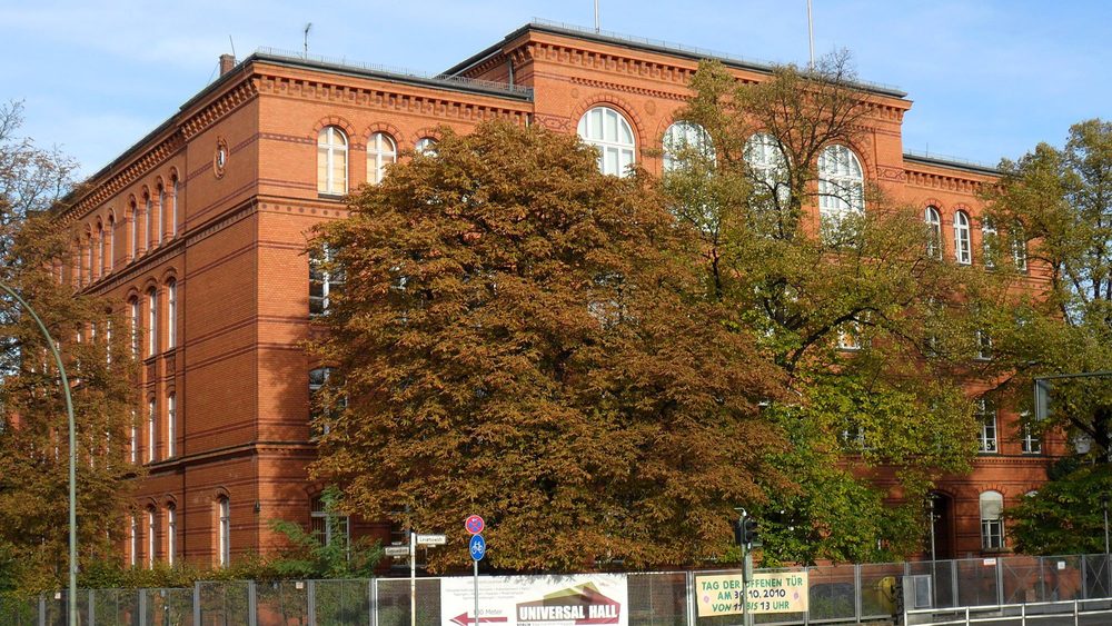 Red brick Gotzkowsky primary school in Berlin-Moabit framed by autumn trees