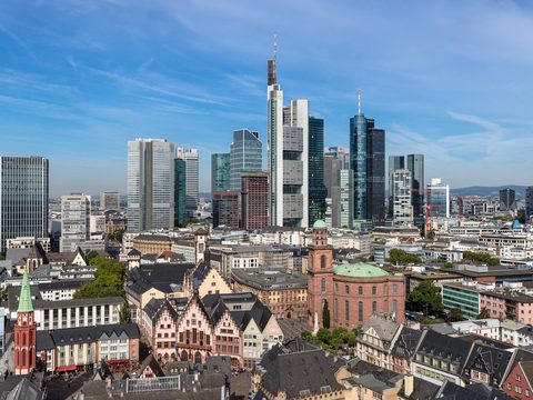 Frankfurt old town rooftops in front of the banking district skyline