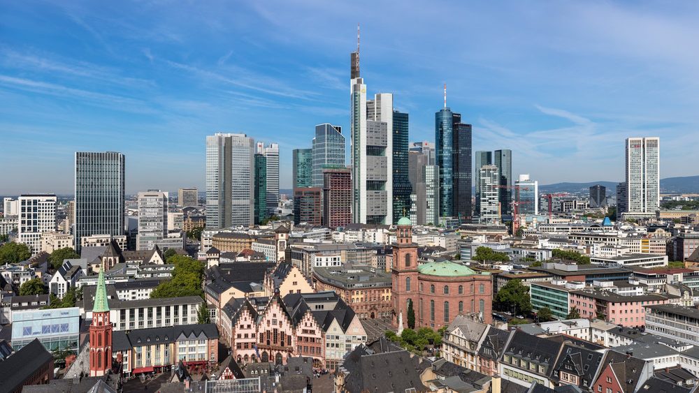 Frankfurt old town rooftops in front of the banking district skyline