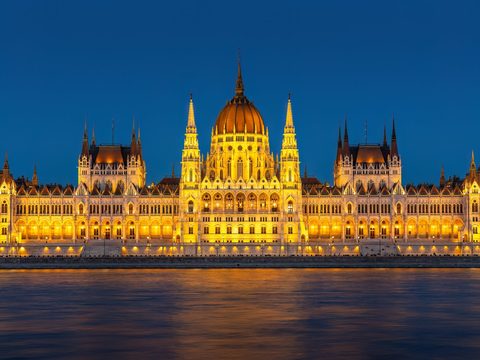 Hungarian Parliament Building in Budapest lit up at dusk