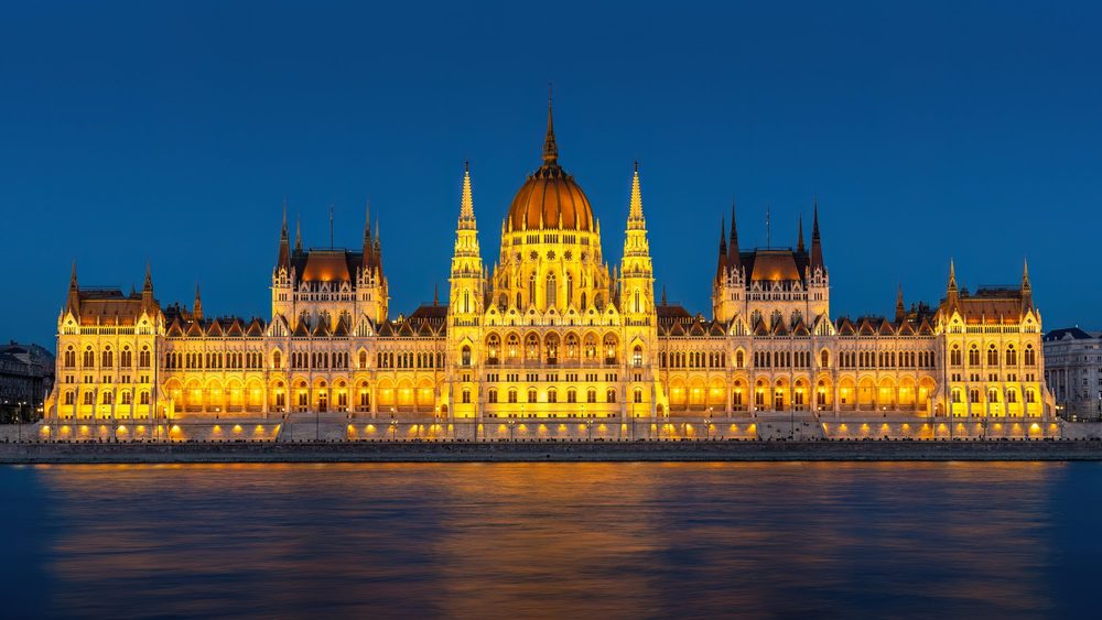 Hungarian Parliament Building in Budapest lit up at dusk