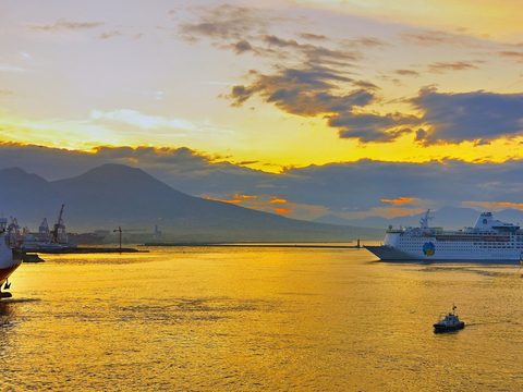 The harbor of Naples at dawn with Mount Vesuvius on the horizon
