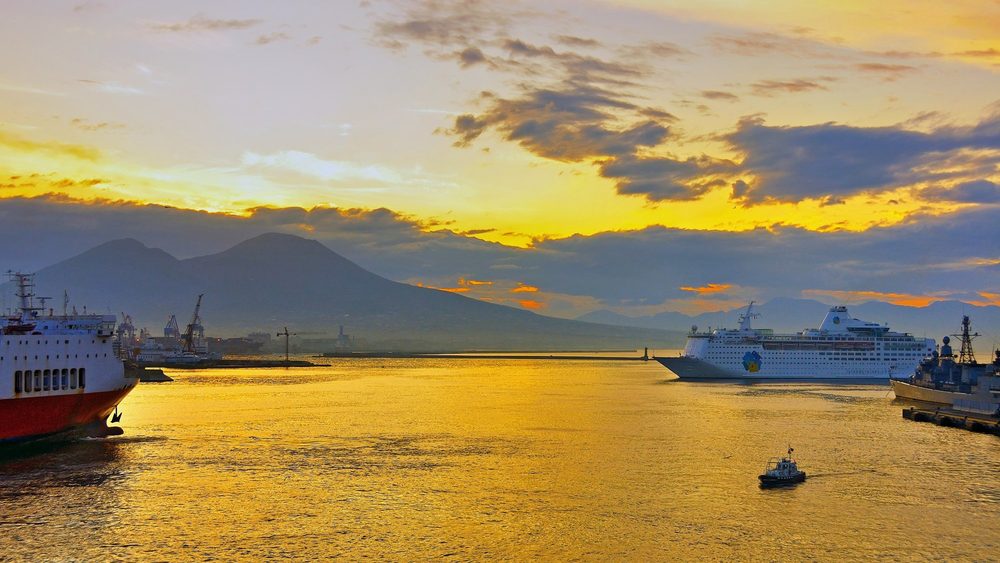 The harbor of Naples at dawn with Mount Vesuvius on the horizon