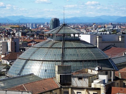 The glass dome of the Galleria Vittorio Emanuele II seen from the rooftops of central Milan