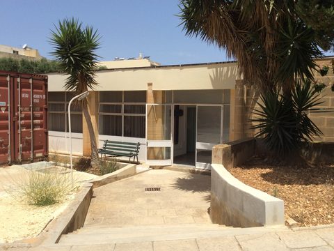 Entrance area of Gozo General Hospital with palm trees