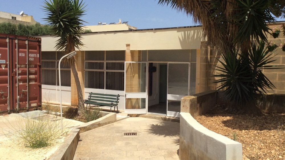 Entrance area of Gozo General Hospital with palm trees