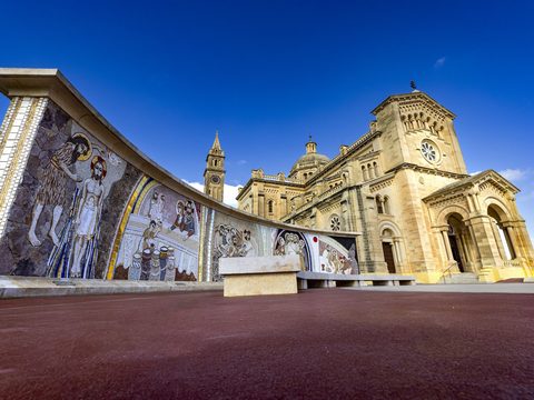 Ta' Pinu basilica in the Gozo countryside under a blue sky