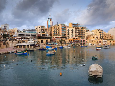 Spinola Bay in St Julian's with fishing boats and waterfront buildings