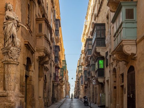 Narrow Saint Christopher Street in Valletta with wooden balconies